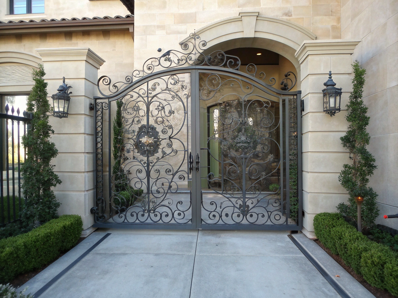 Luxury hand-forged iron entryway gate with bronze accents